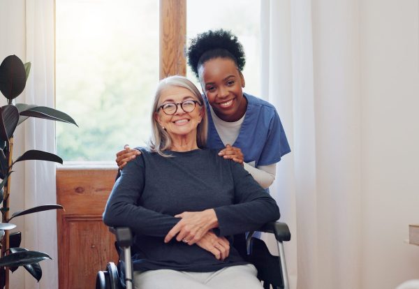 Senior care, nurse and old woman with wheelchair, portrait and smile in health at nursing home. Support, kindness and happy face of caregiver with elderly person with disability for homecare service